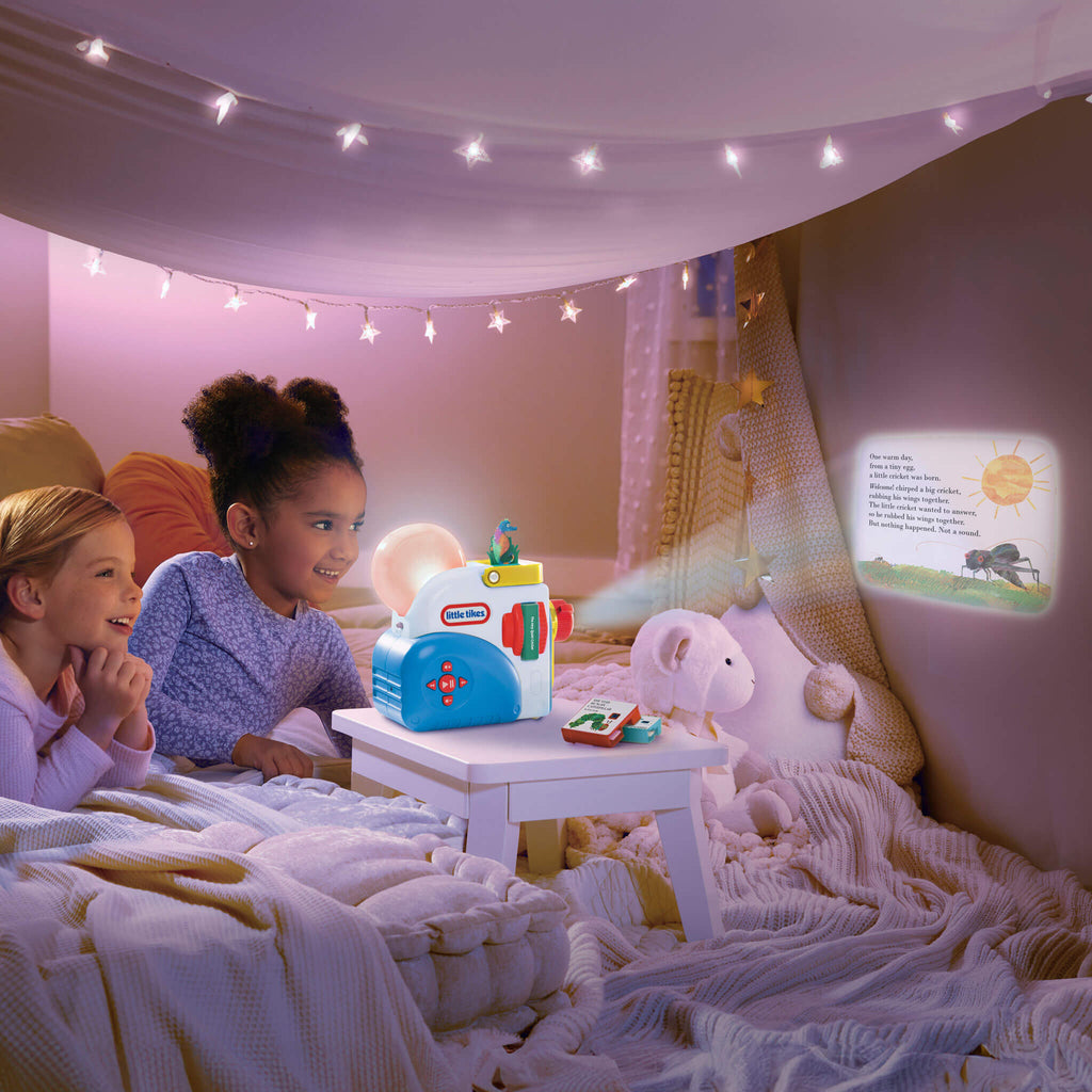 Two children in a cozy room with a Little Tikes toy and a night light.