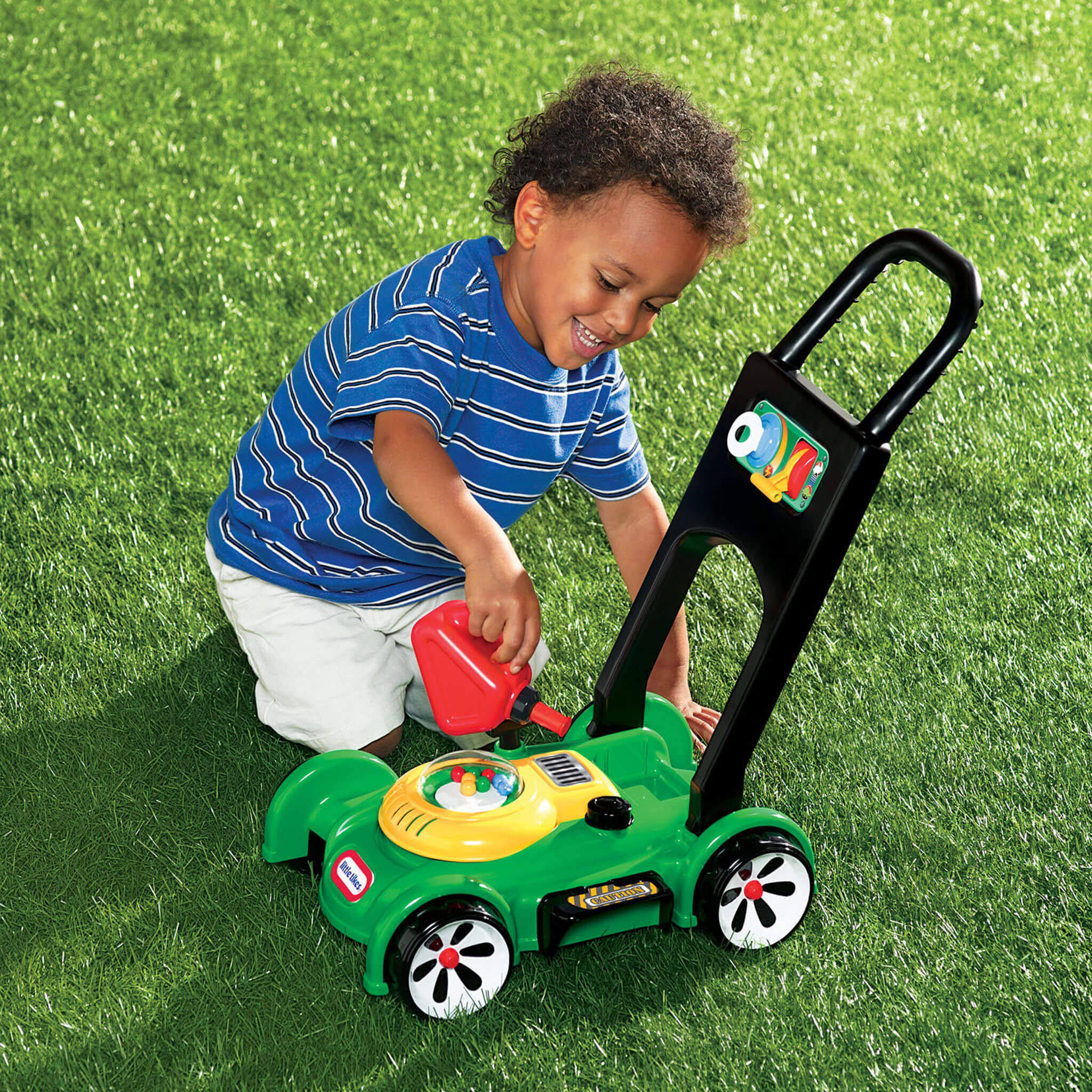 Child pretending to fill mower with gas can