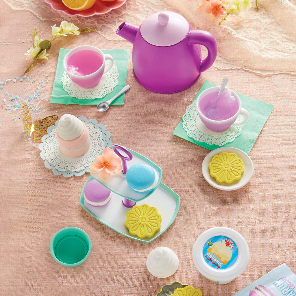 Colorful toy tea set with a purple teapot and cookies